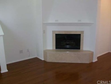 The cozy living room has a gas fireplace with elec