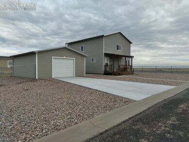 View of front of house featuring a garage, an outd