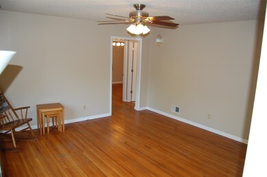 Large living room with wood floors and new paint