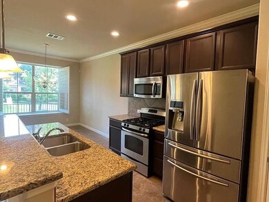 Kitchen with visible vents, crown molding, stainl