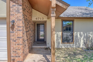 View of exterior entry featuring brick siding and 