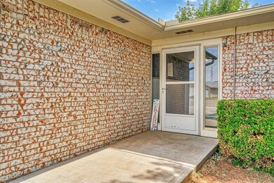 Doorway to property featuring a patio area