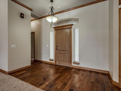 Foyer with dark hardwood / wood-style flooring and