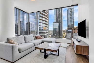 Living area featuring a wall of windows, baseboar
