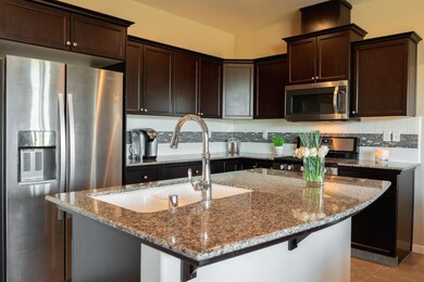 Beautiful granite countertops, a tile backsplash, 