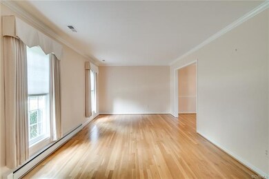 Living Room space, beautiful hardwoods, Crown Moulding.