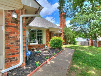 Entrance to property with brick siding, a chimney, and a shingled roof