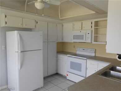 Kitchen featuring white appliances, light tile pat
