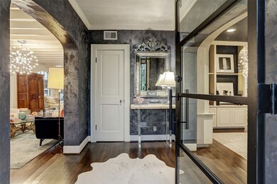 Steel door opens to the stylish entry with venetian plaster finished walls flanked by the living room and dining room.
