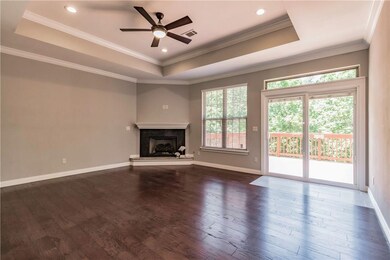 Bright & cheery Living w/fireplace, hardwood flrs, trayed ceiling & crown moldings.