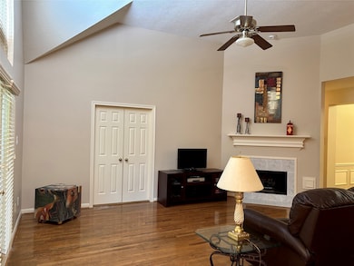 A spacious family room with vaulted ceilings, a co