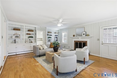 A large family room with built-in bookcases and wood burning fireplace.