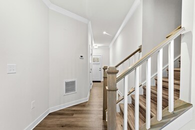 Staircase featuring hardwood / wood-style flooring
