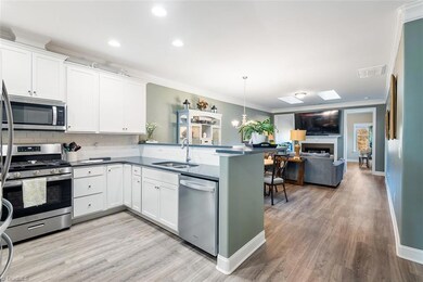 Kitchen features quartz counters, subway tile, stainless steel appliances, gas stovetop w/griddle, refrigerator conveys.