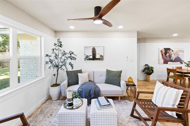 Living room featuring ceiling fan and wood-type fl