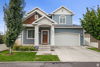 View of front of property featuring driveway, board and batten siding, and an attached garage