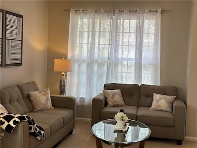 Living room with baseboards and light colored carp