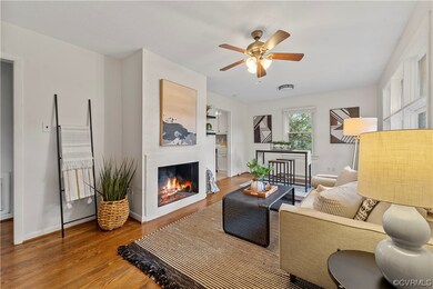 Living room with a fireplace, light hardwood floor