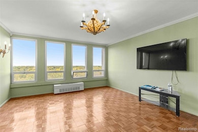 Unfurnished living room featuring ornamental molding and a chandelier