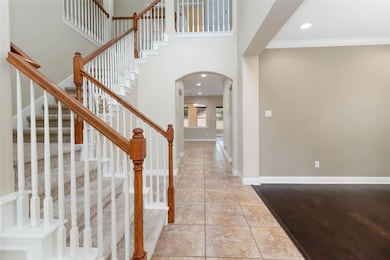 Foyer featuring arched walkways, ornamental moldi