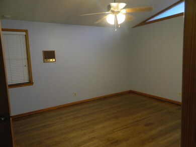 Unfurnished room with vaulted ceiling, ceiling fan