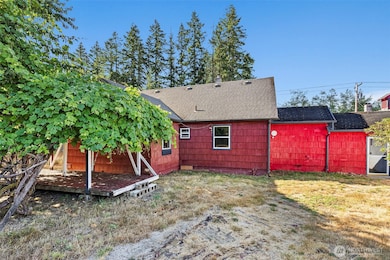 Back of house with large grape arbor.