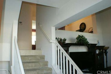 Stairs heading to second level where kitchen is