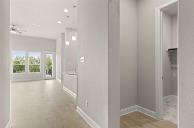 Hall with light wood-style floors, baseboards, an