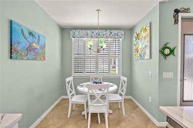 Dining room featuring baseboards, light tile patte