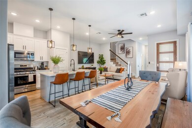 An entertainment space equipped with a dining room chefs kitchen and living space.