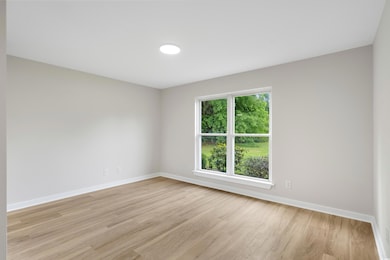 Spare room featuring light wood finished floors an