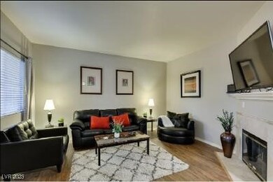 Living area with wood finished floors, a high end