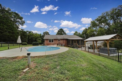 View of pool featuring a lawn, a patio, a gazebo, 