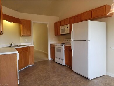 The kitchen is open and includes all of the appliances (stove, built-in microwave, dishwasher, and refrigerator with an ice maker.  The flooring has also recently been installed.