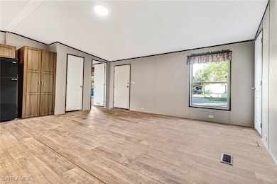 Unfurnished living room with light hardwood / wood