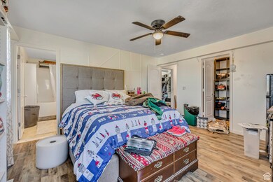 Bedroom featuring ceiling fan, light wood-style flooring, and a closet