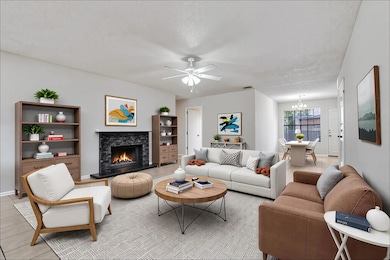 Living area featuring a chandelier, a fireplace, 