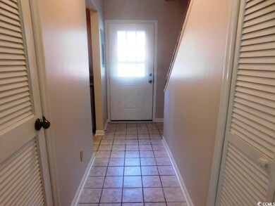 Doorway to outside with light tile patterned floor