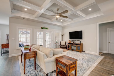 Living room with french doors, coffered ceiling, w