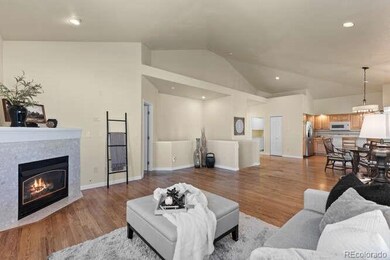 Open concept layout with vaulted ceilings and seamless flow from living to dining to kitchen