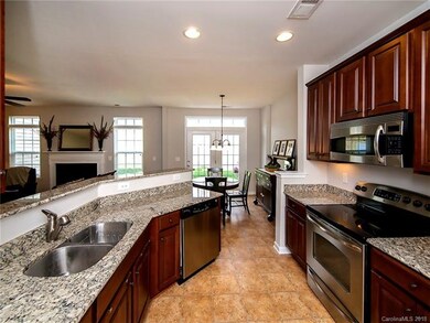 Open kitchen with cherry cabinets, granite, stainl