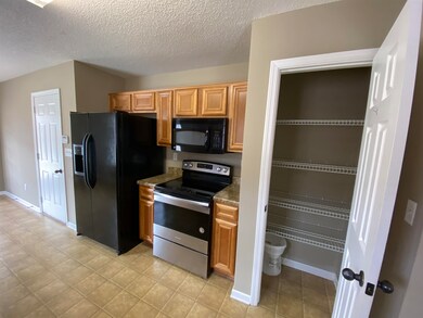 Kitchen featuring a textured ceiling, light stone 