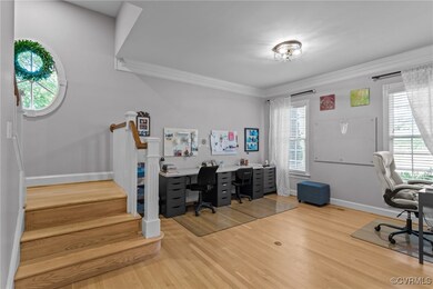 Home office featuring crown molding, plenty of nat