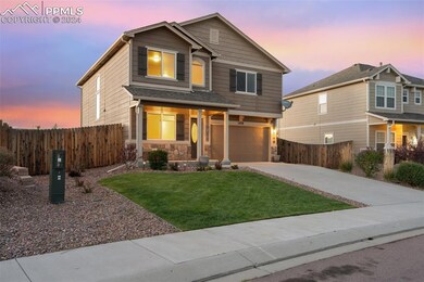 Craftsman house featuring a garage and a yard