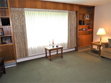 Large Bay window flanked by built in book cases an