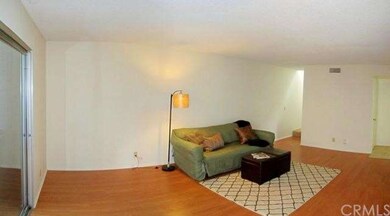 Spacious living room with new laminate flooring.