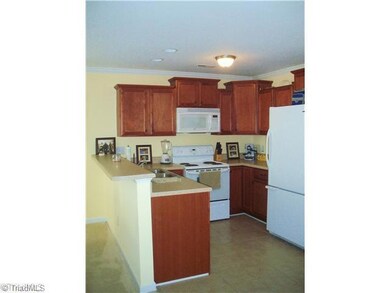 Kitchen. Cooks Kitchen offers gorgeous wood cabinets with updated knobs, neutral countertops, tile floors, breakfast bar, and all appliances remain!