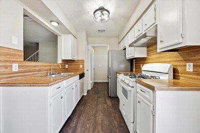 Kitchen with white appliances, under cabinet rang