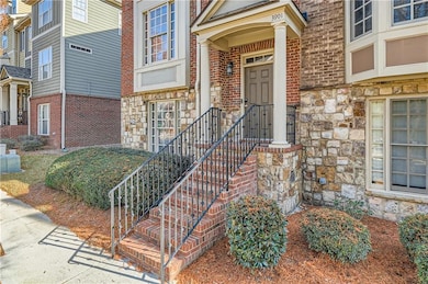 View of exterior entry featuring stone siding