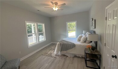 Bedroom featuring multiple windows, ceiling fan, a